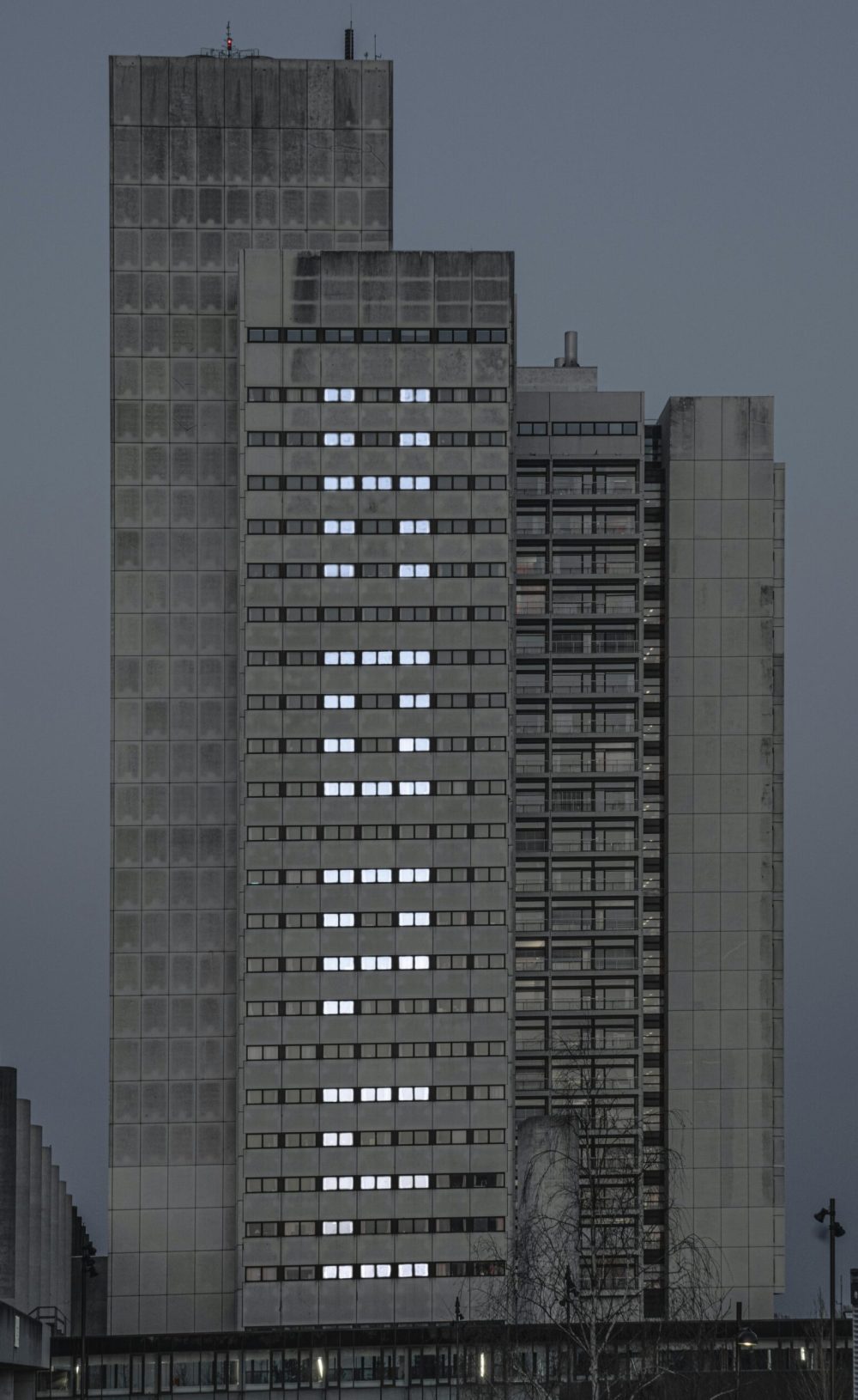 Modern skyscraper in Denmark with illuminated window pattern at night.